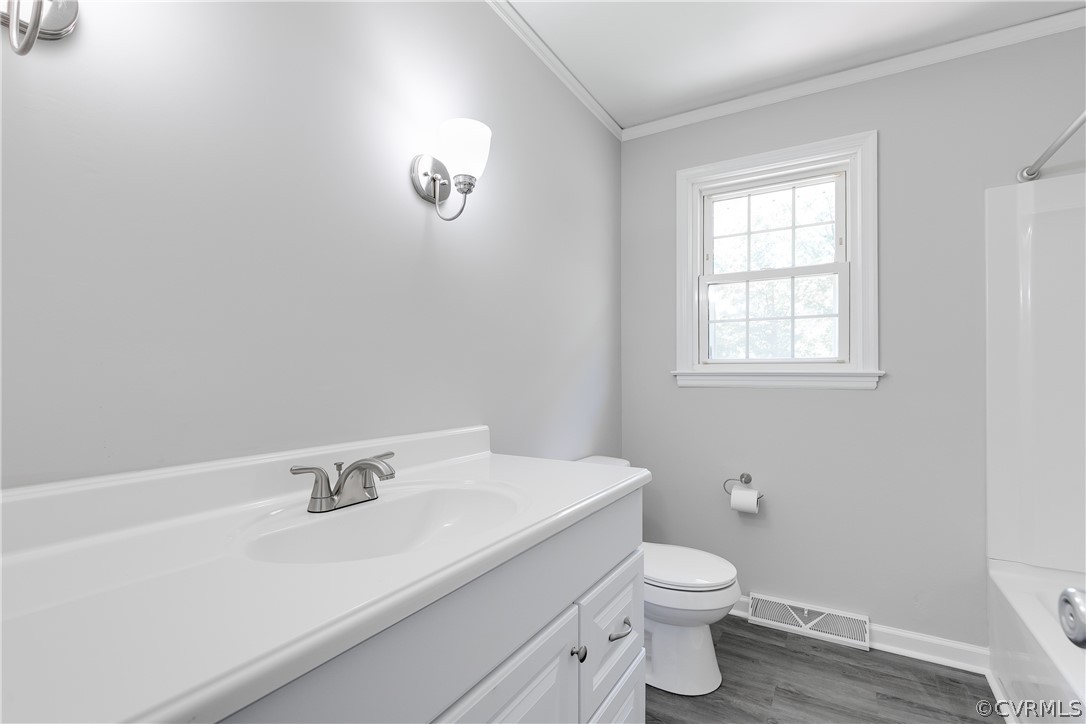 14911 Rowlett Road Chesterfield, VA 23838 - Photo 10 of 50 a bathroom with a sink a toilet and a window