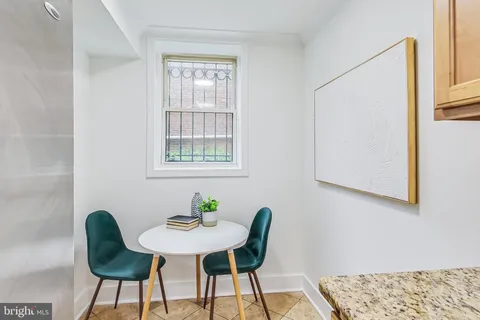 a view of a dining room with furniture and a window