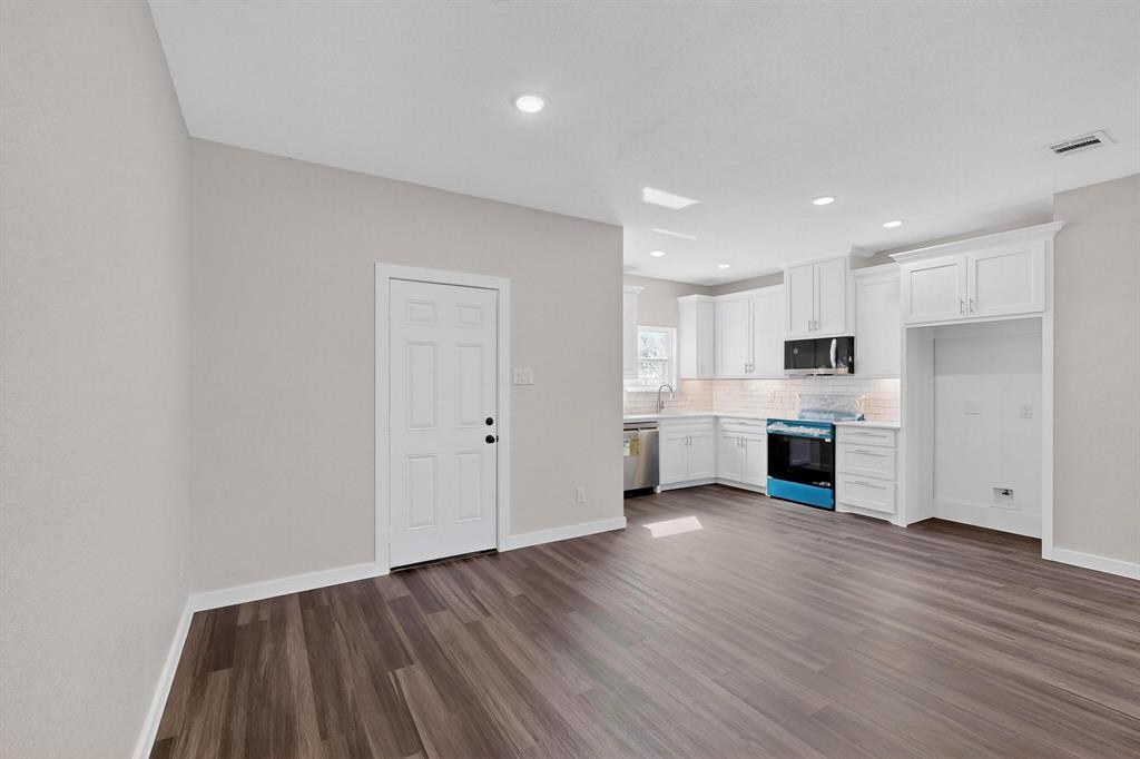 740 Section House Road Ennis, TX 75119 - Photo 12 of 37 a view of kitchen with wooden floor and electronic appliances