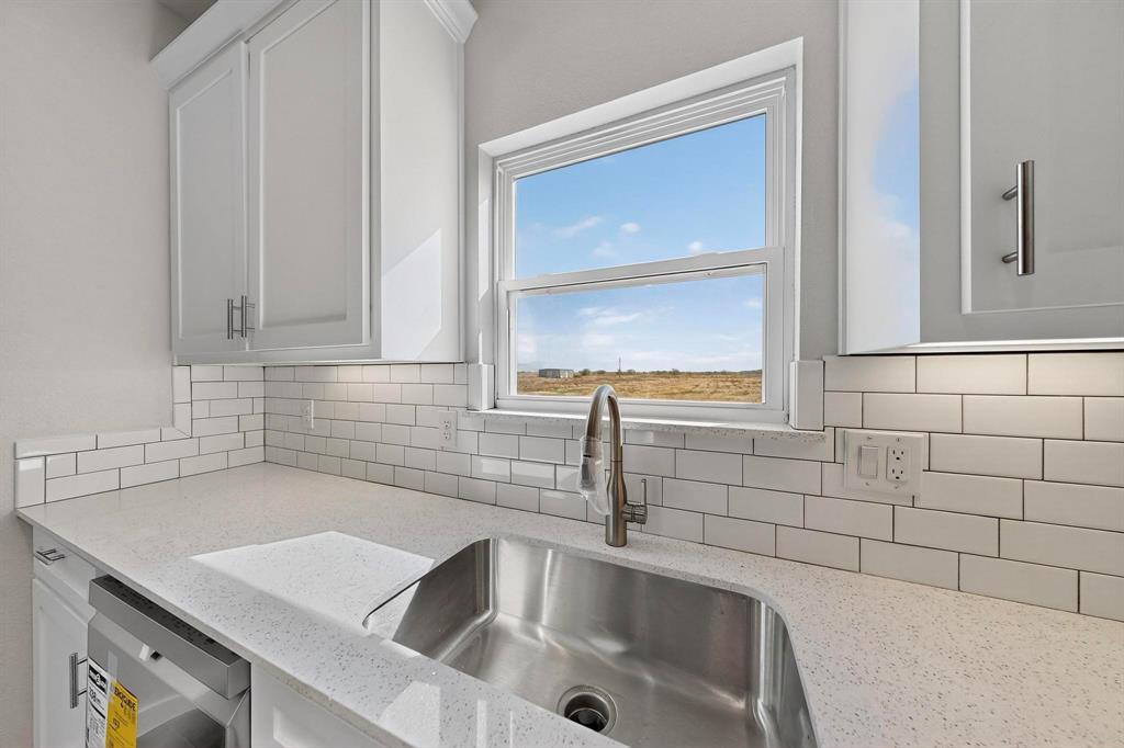740 Section House Road Ennis, TX 75119 - Photo 14 of 37 a kitchen with a sink and cabinets