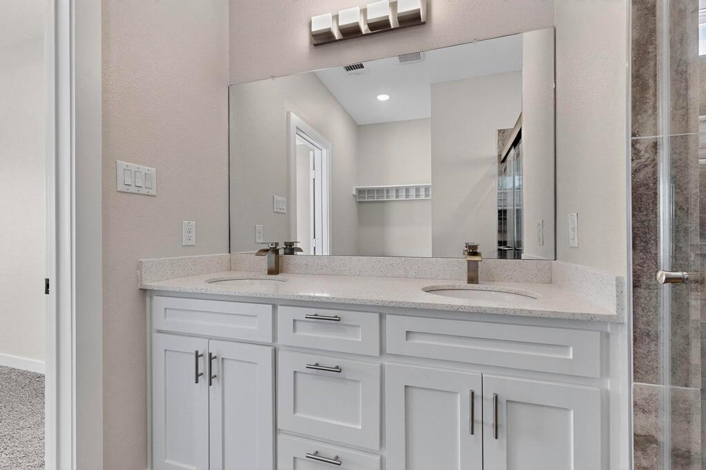 740 Section House Road Ennis, TX 75119 - Photo 25 of 37 a bathroom with a double vanity sink and a mirror