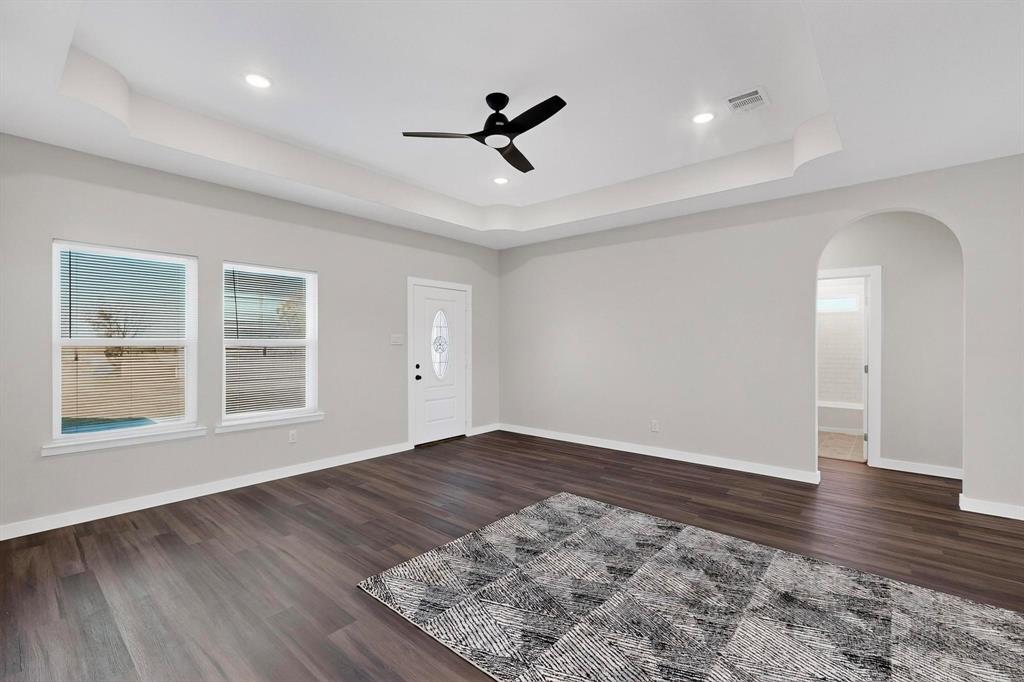 740 Section House Road Ennis, TX 75119 - Photo 9 of 37 an empty room with wooden floor and windows