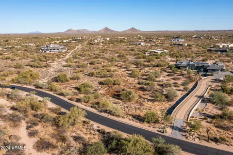 an aerial view of residential houses with city view