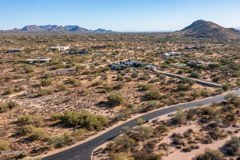 an aerial view of residential houses with city view