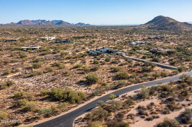 an aerial view of residential houses with city view