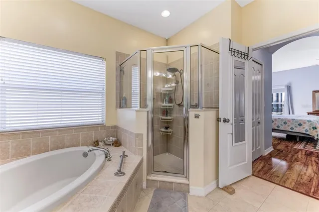 a bathroom with a tub shower and sink