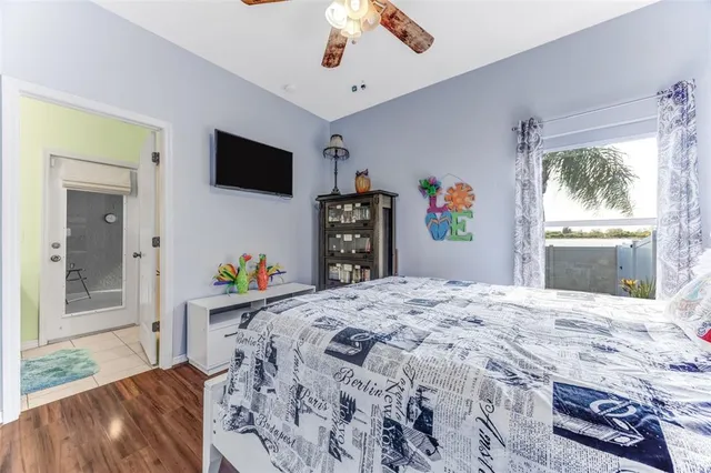 a bedroom with a bed and a flat screen tv