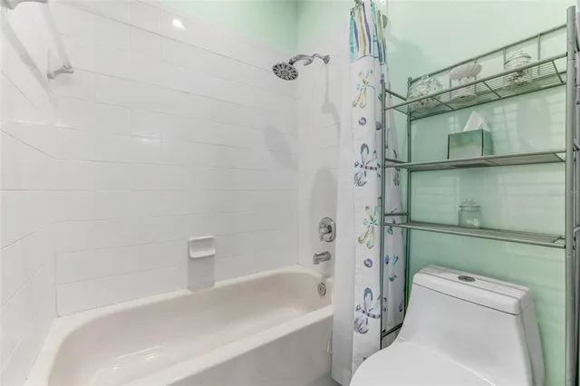 a bathroom with a shower a toilet and a sink