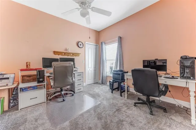 a view of a workspace with furniture and a window