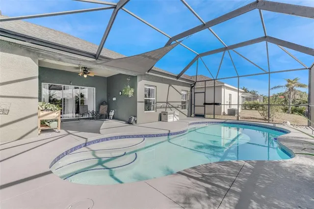 a view of a backyard with furniture and table under an umbrella
