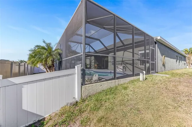 a view of a house with a small yard and wooden fence