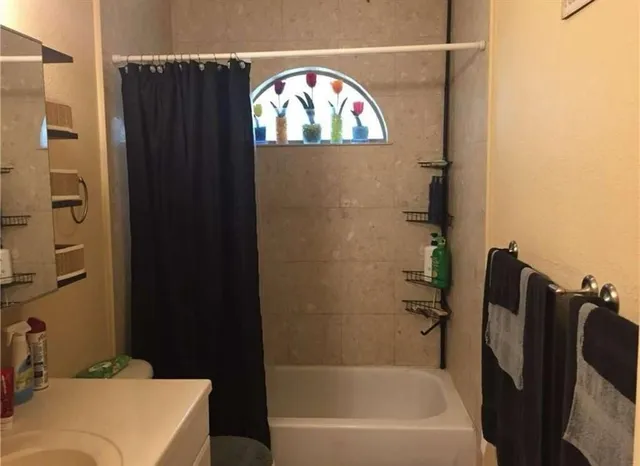 a bathroom with a bathtub and a wooden floor