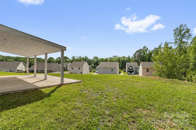 a swimming pool with lots of tress in front of it
