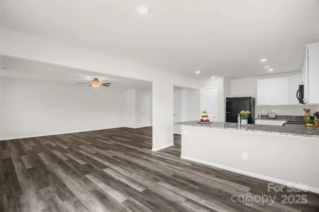 a view of kitchen with refrigerator sink and wooden floor