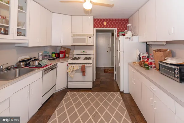 a kitchen with a white cabinets and white appliances