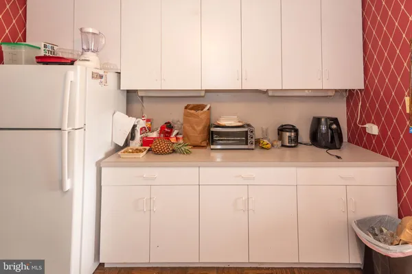 a kitchen with refrigerator and cabinets