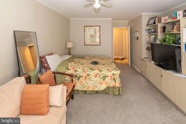 a bedroom with a bed and flat screen tv