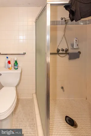 a bathroom with a toilet and a shower