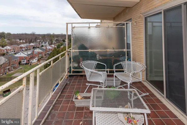 a balcony with table and chairs