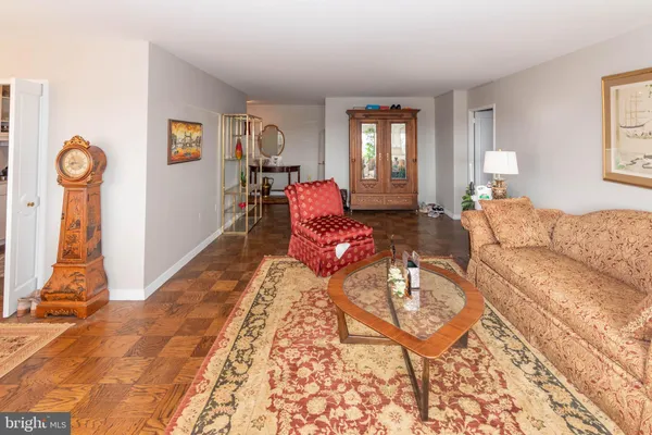 a living room with furniture a rug and a window