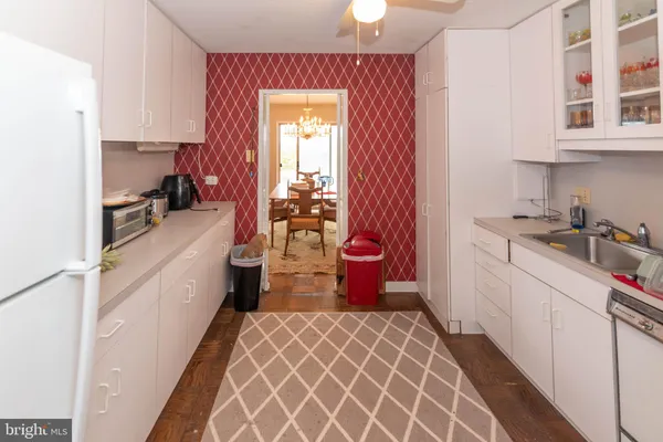 a kitchen with a sink cabinets and appliances