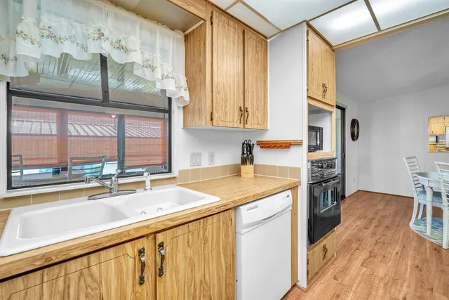 a kitchen with stainless steel appliances granite countertop a sink and a counter space