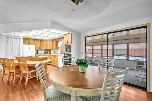 a dining room with furniture window and wooden floor