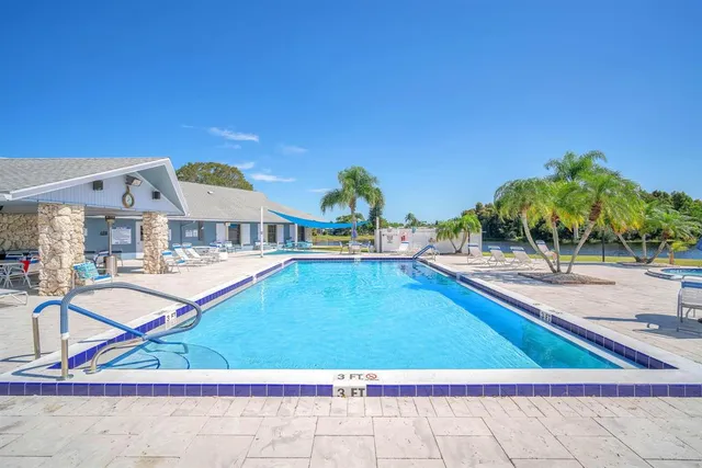 a view of swimming pool with outdoor seating