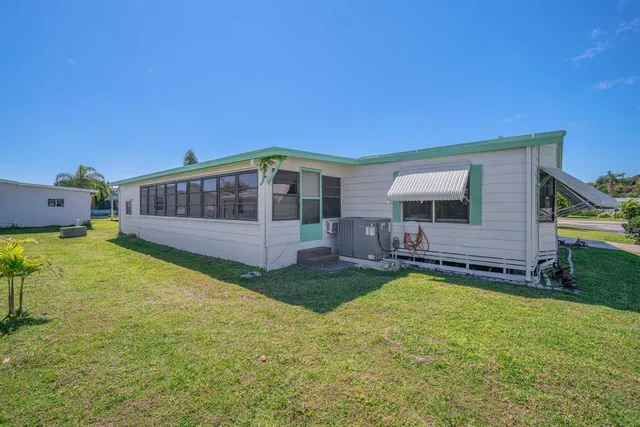 a view of a house with backyard and sitting area