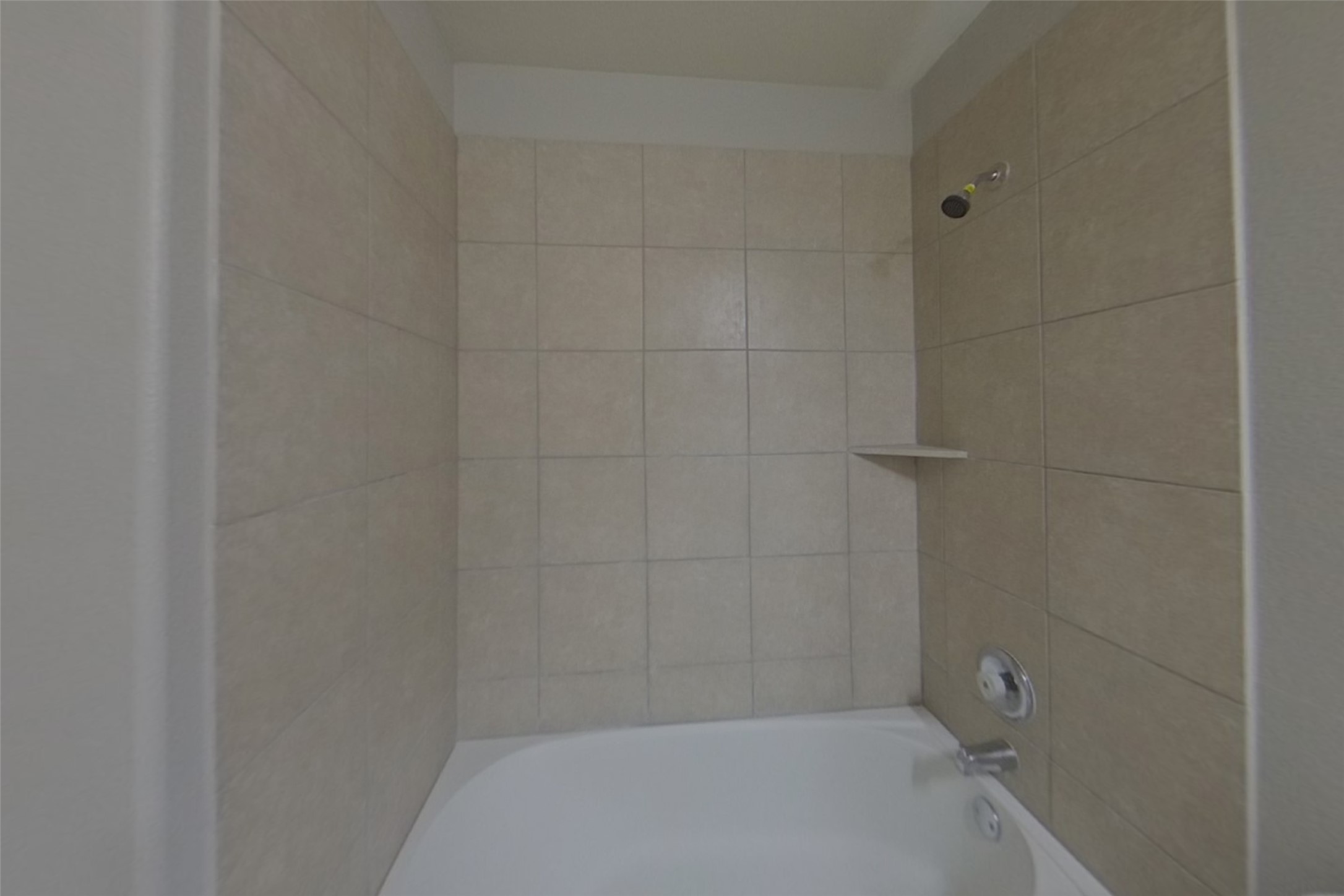 240 Dragon Ridge Road Buda, TX 78610 - Photo 15 of 20 Clean lines and ceramic tile surround highlight this classic tub and shower combination.