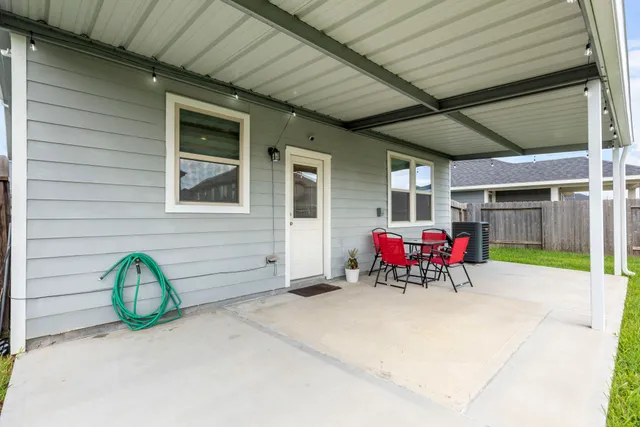 a view of a patio with table and chairs