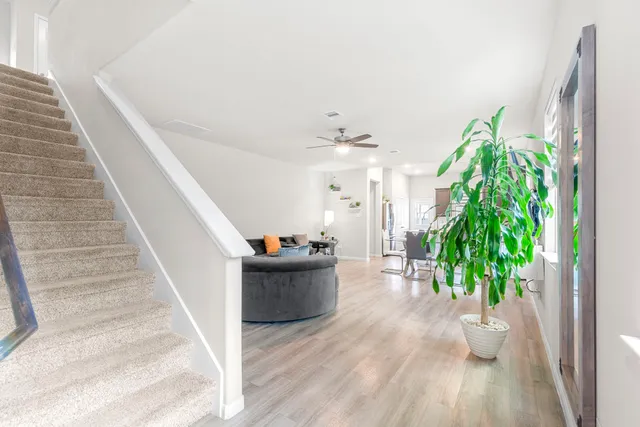 a view of entryway and hall with wooden floor
