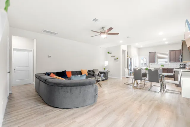 a living room with furniture and kitchen view
