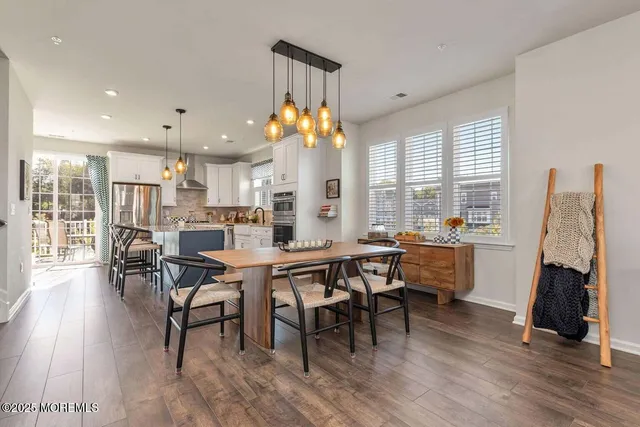 a dining room with furniture and wooden floor