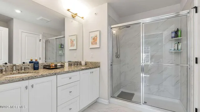 a bathroom with a shower sink and mirror
