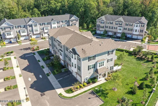 an aerial view of residential houses with yard