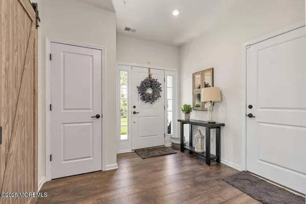 wooden floor with white cabinets and wooden floor