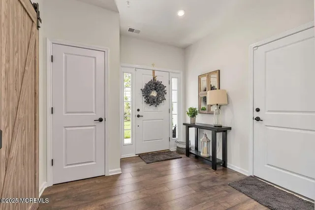wooden floor with white cabinets and wooden floor