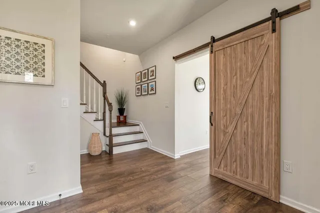 a view of entryway with stairs and wooden floor