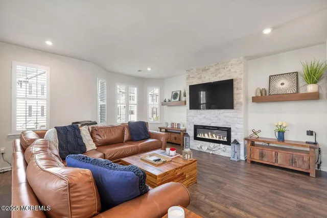 a living room with furniture flat screen tv and a fireplace