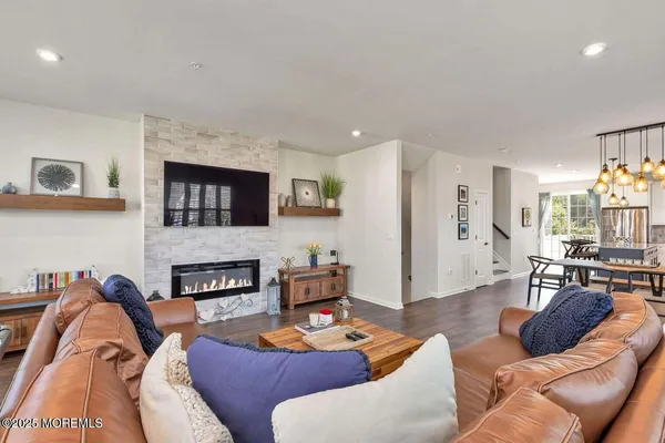 a living room with furniture fireplace and a flat screen tv