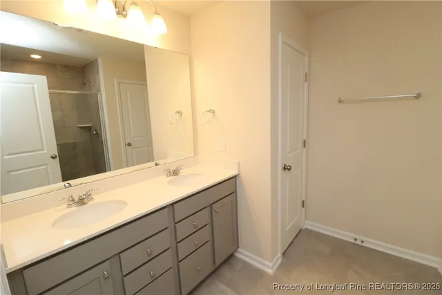 a bathroom with a double vanity sink and a mirror
