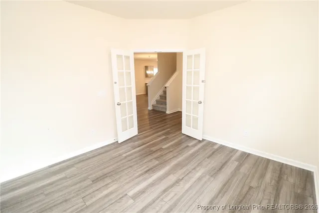 a view of a hallway with wooden floor