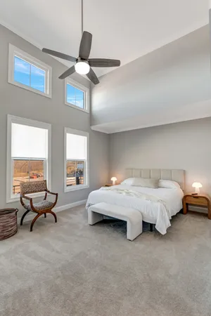 a spacious bedroom with a bed and a couch