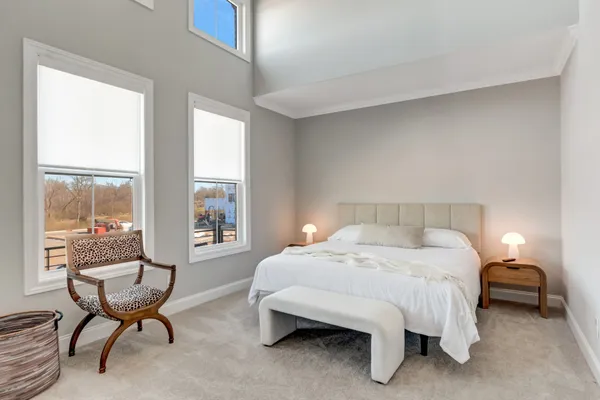 a bedroom with a bed chair and window