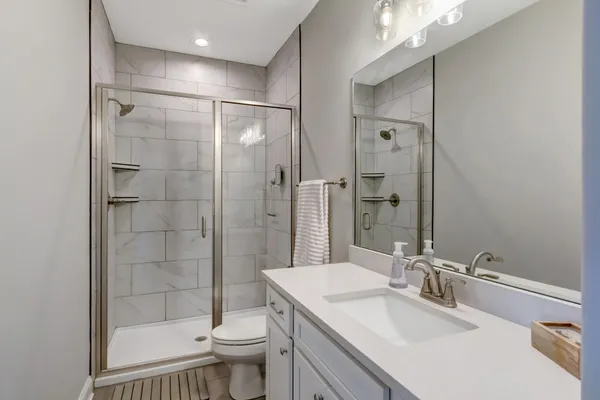 a bathroom with a sink toilet and shower