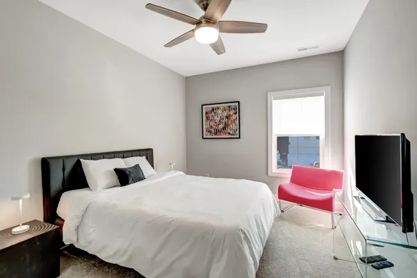 a bedroom with a bed and a flat screen tv