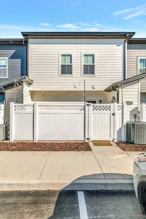 a view of a house with a car parked on the road