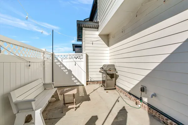 a view of a patio with table and chairs with wooden floor and fence