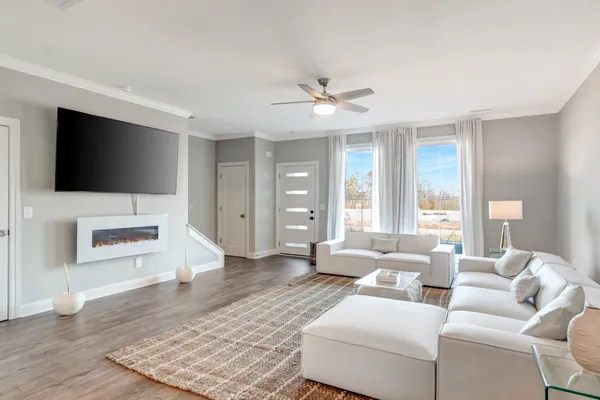 a living room with furniture and a flat screen tv